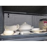 Cage containing cream and white glazed tureens, bowls and trays