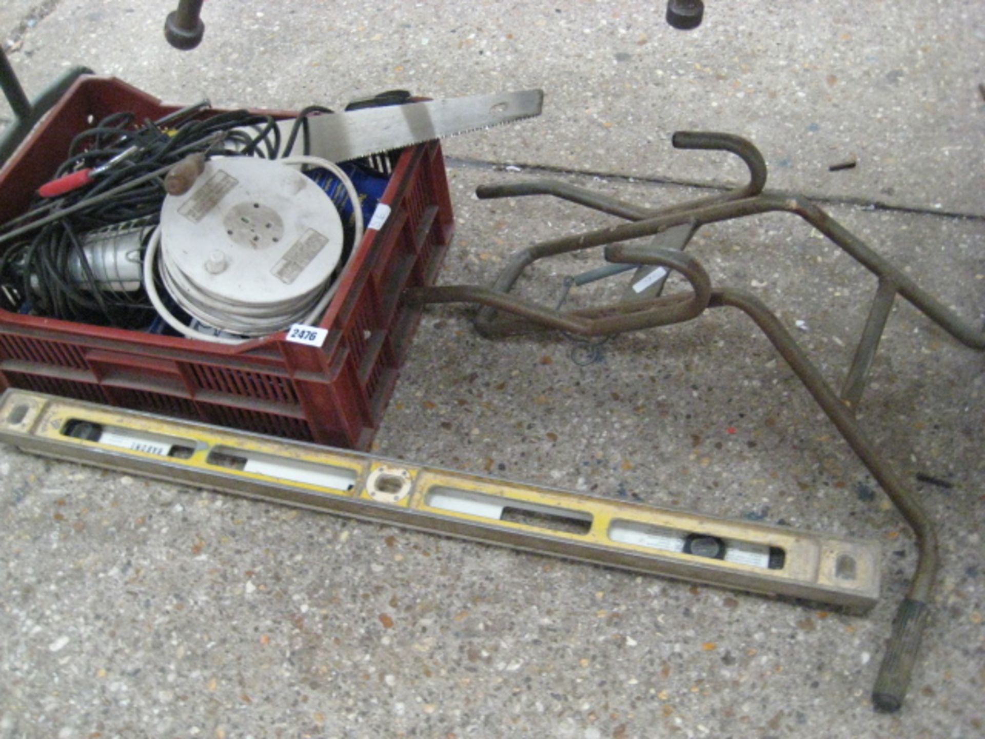 Small under bay containing spirit level, crate of various tools and rack