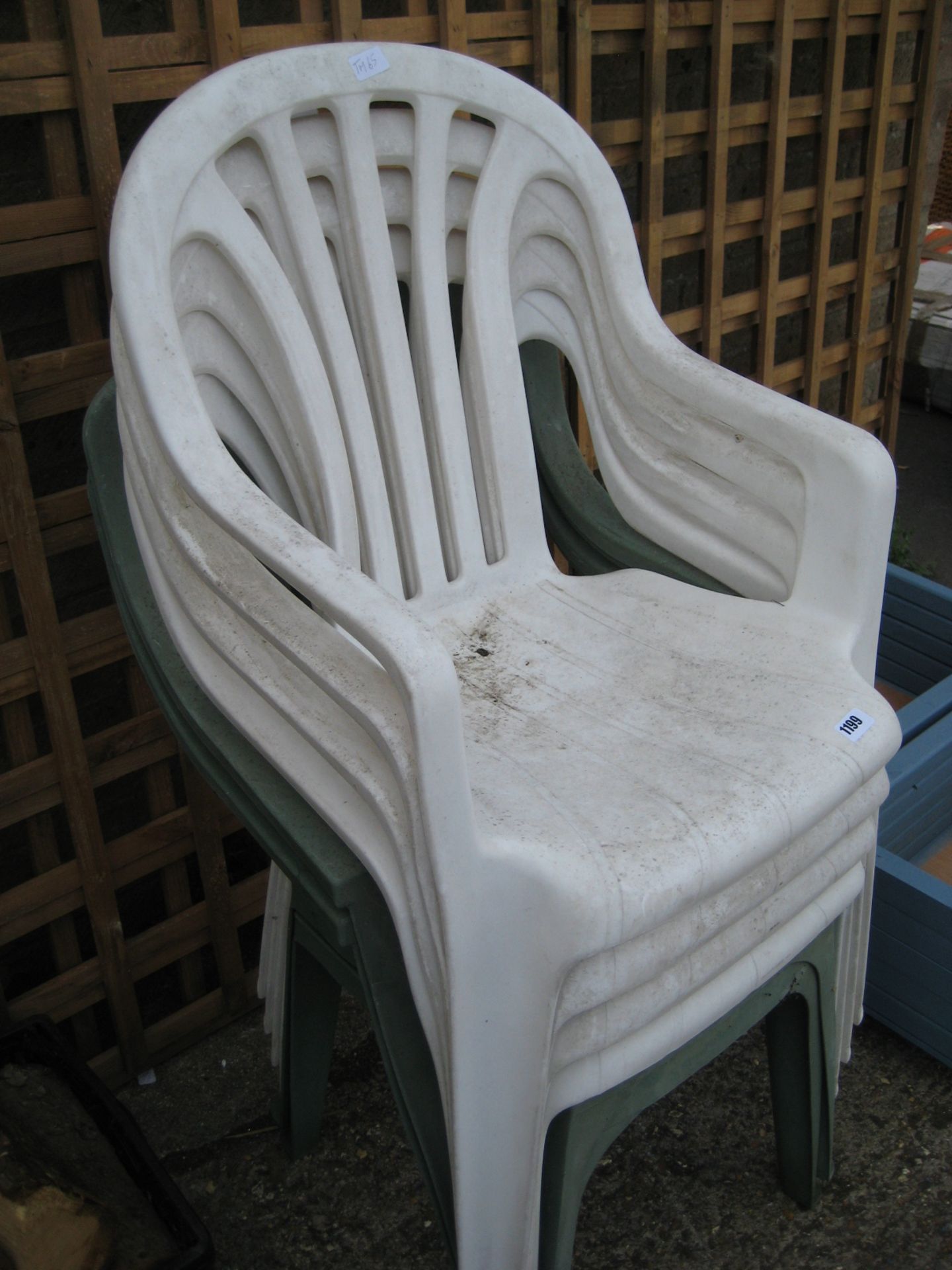 Stack of 6 plastic garden chairs in white and green