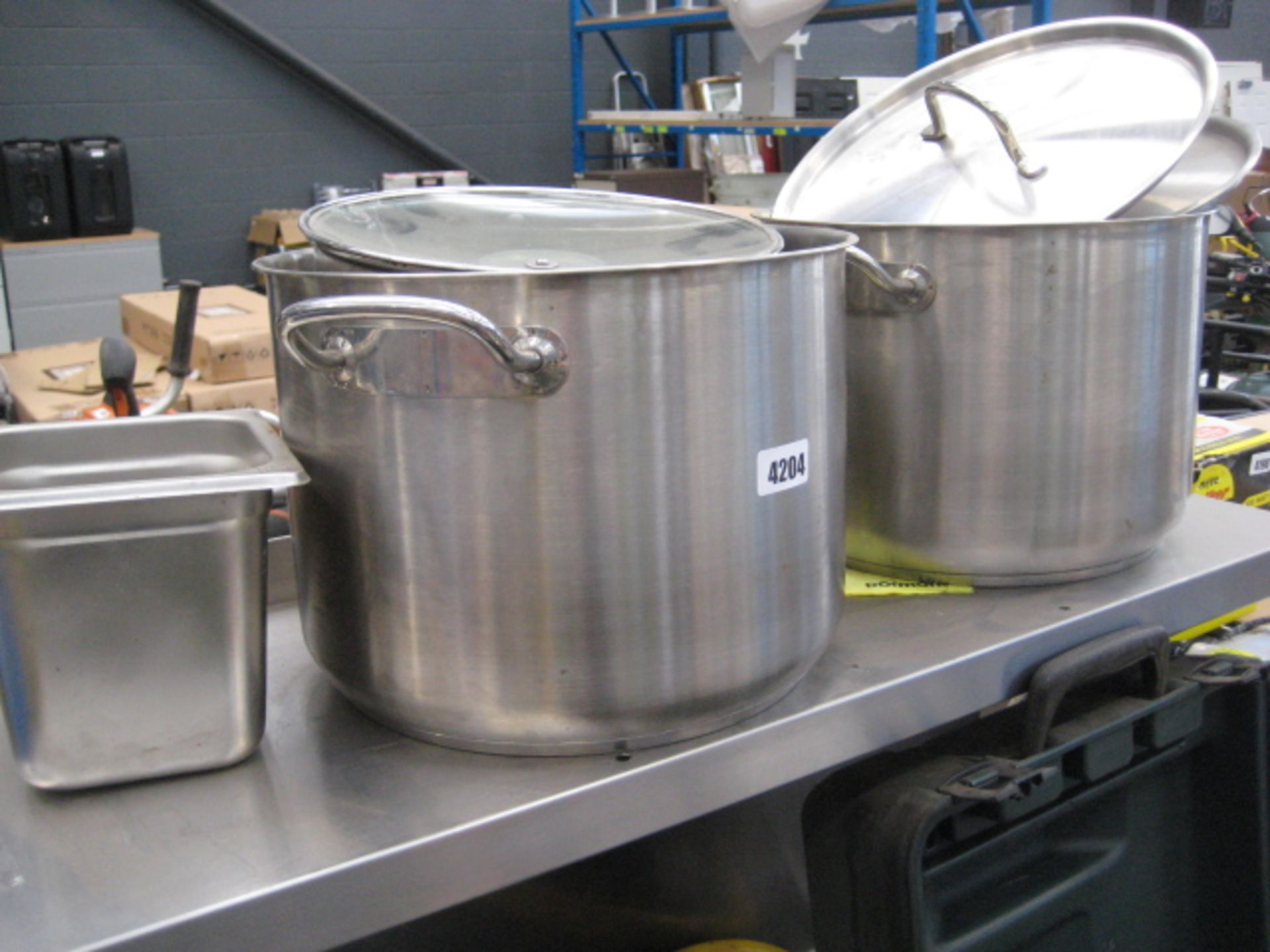 2 various stainless steel cooking pots with lids