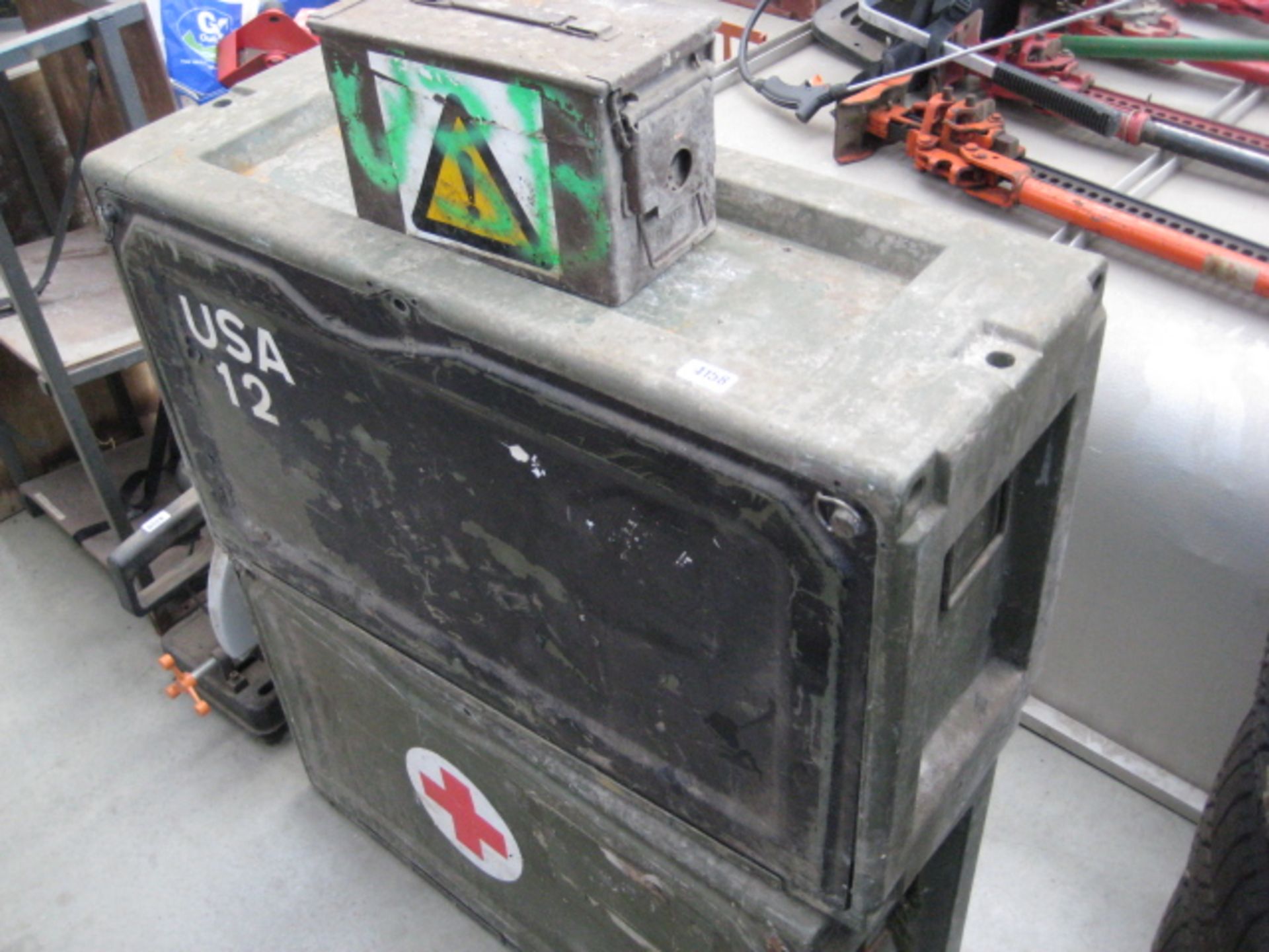 2 large green military storage boxes together with a small ammunition box