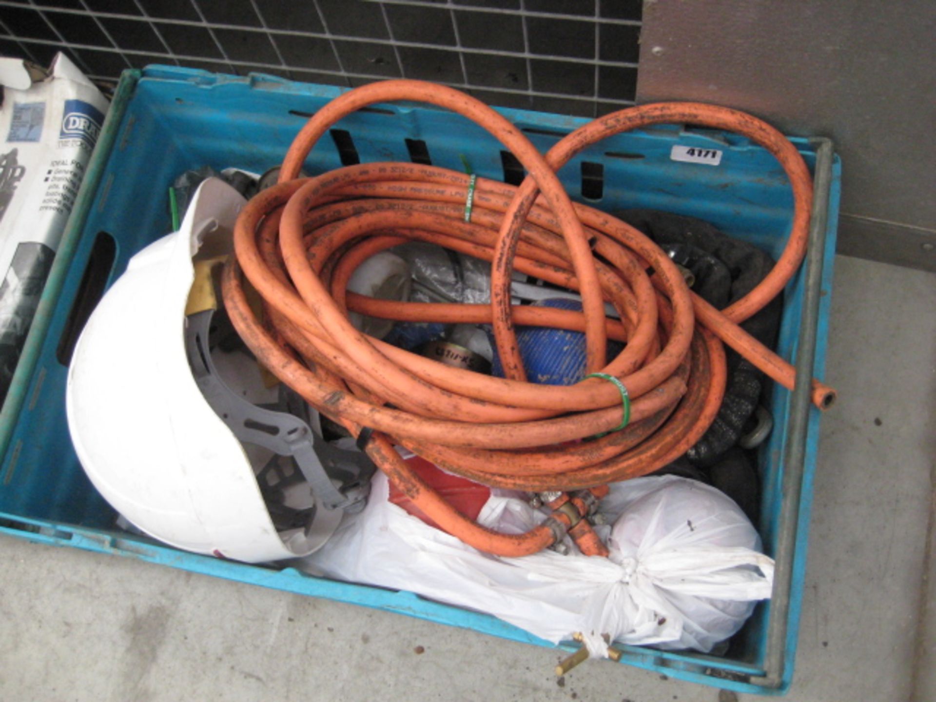 Box containing a quantity of flexible gas pipe, tow hitch, bullcocks chain, hard hat, etc