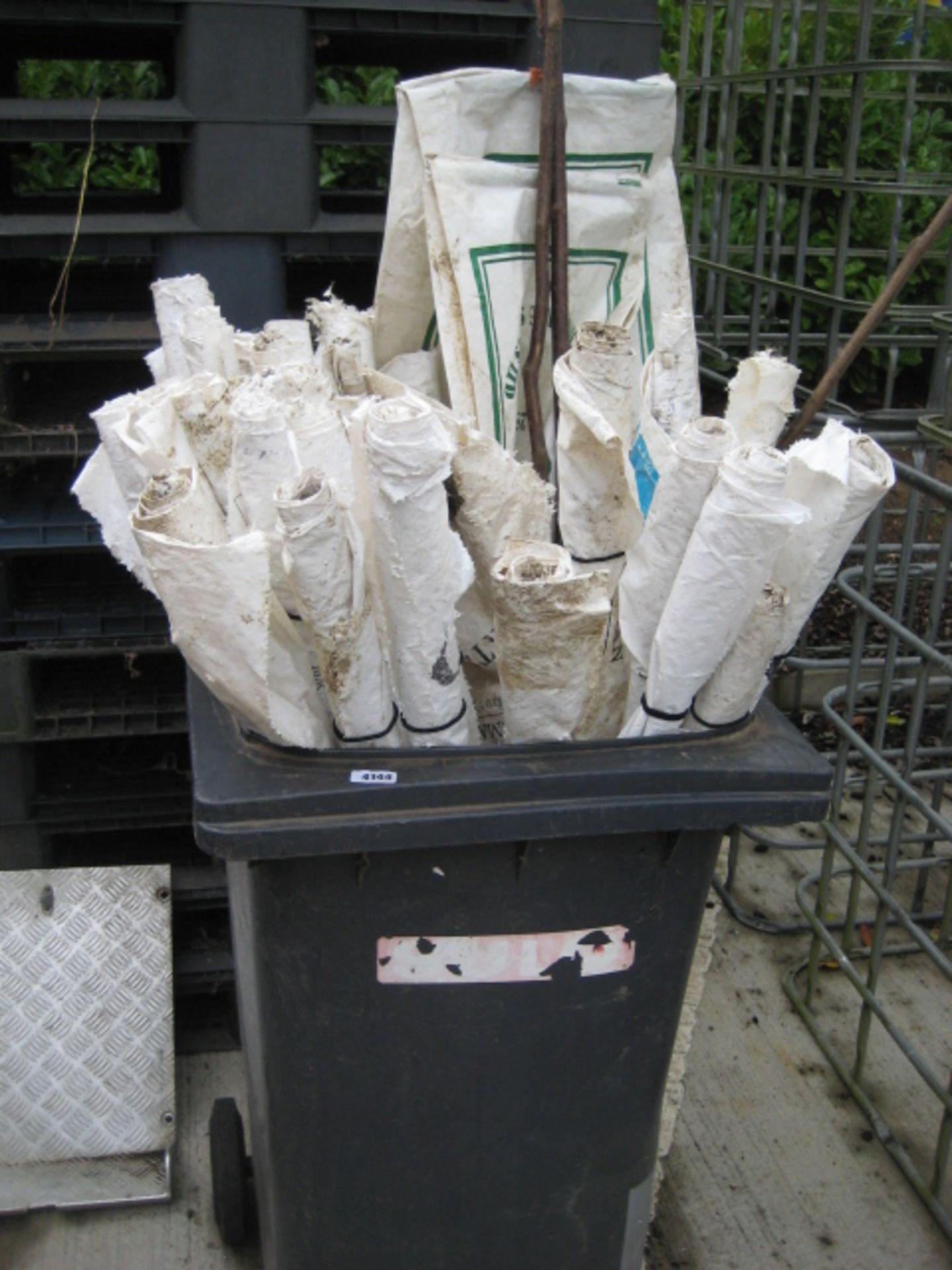 Wheelie bin containing a quantity of Beaters flags