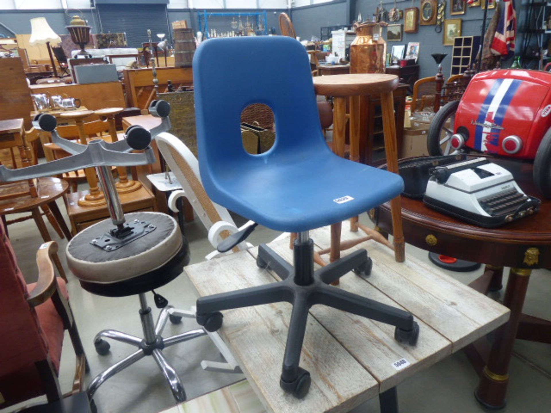 Child's blue swivel chair together with a pine stool