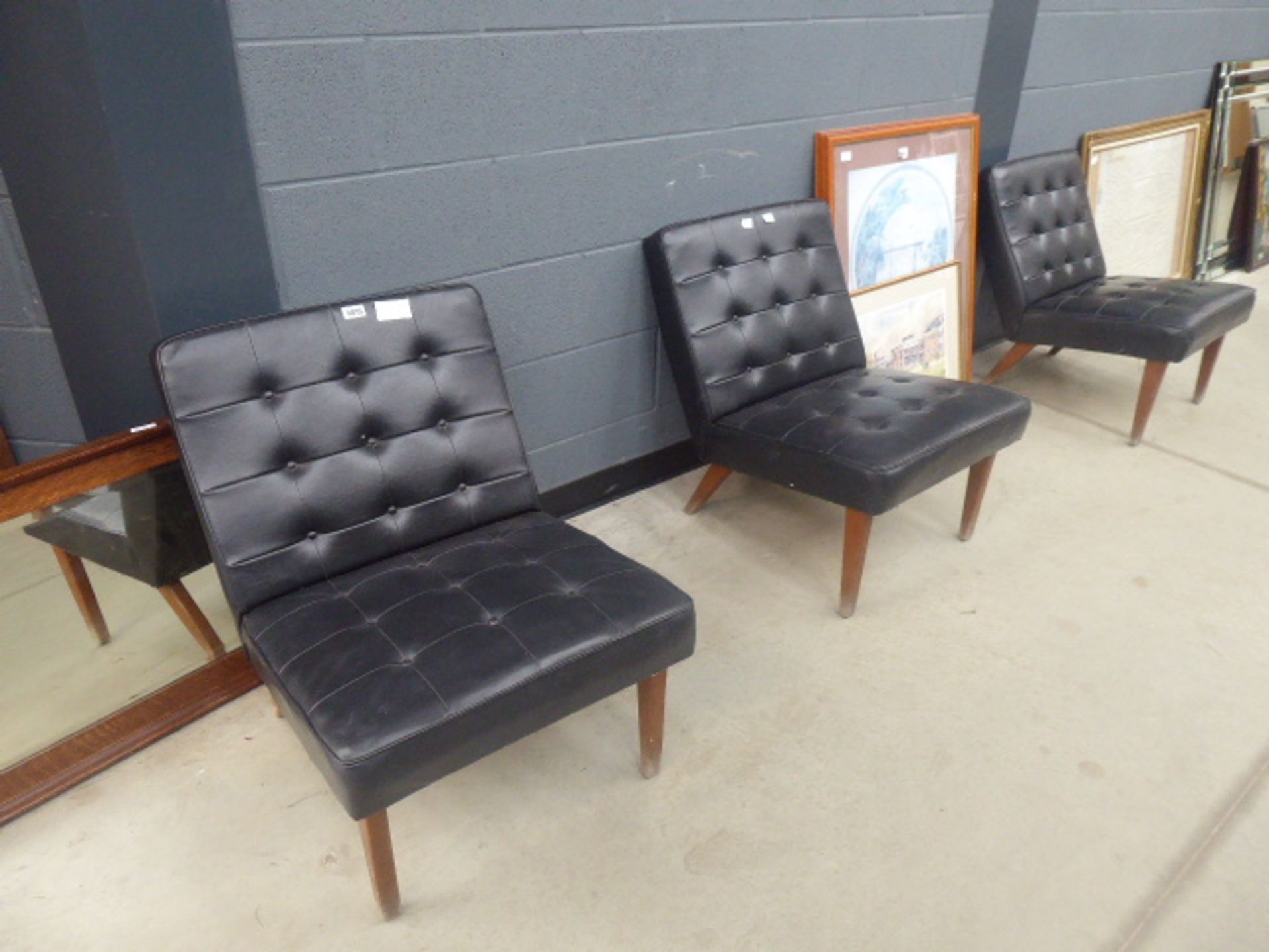 Three 1950/60's black reception type chairs with button back seats, after Robin Day's '