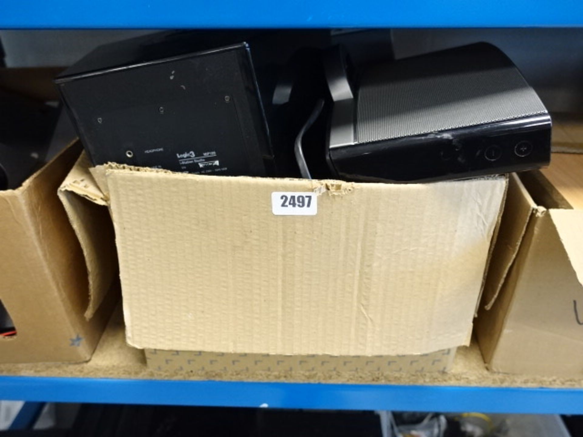 Box containing a quantity of various bluetooth and other speakers