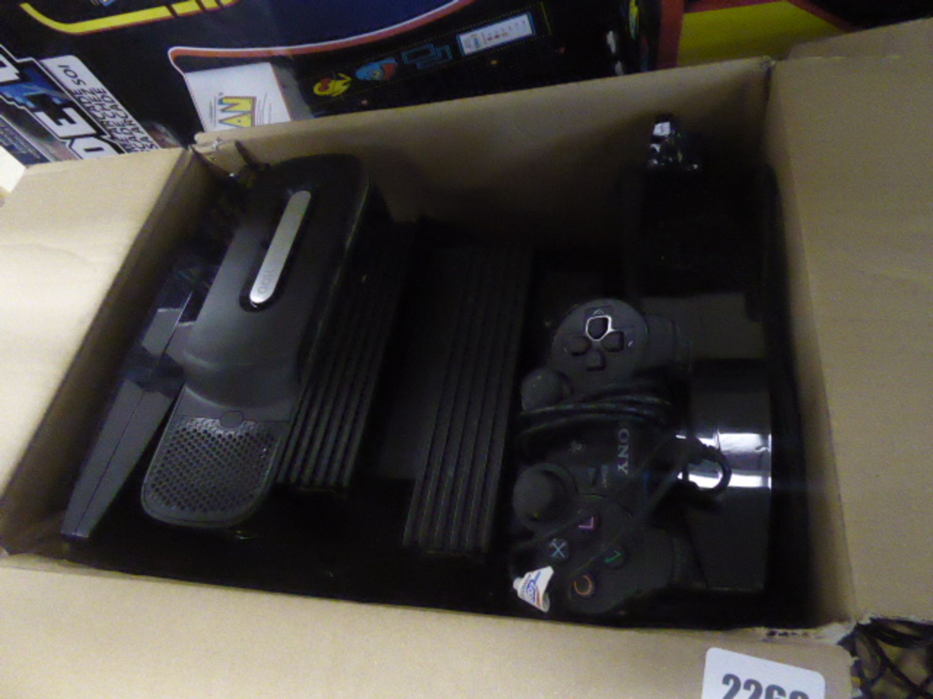 Xbox, Playstation 2 and Playstation 3 consoles in cardboard box