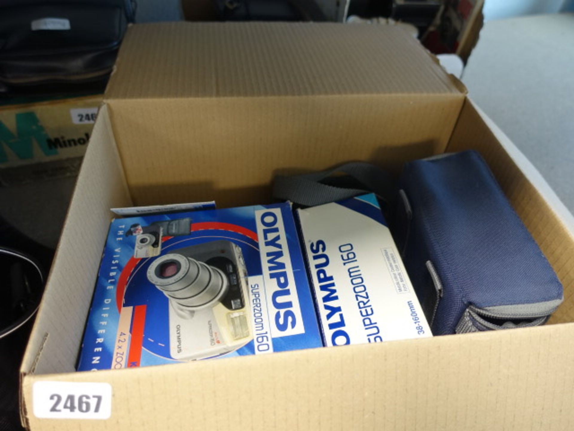 Box containing various kit pieces for Superzoom 160 camera