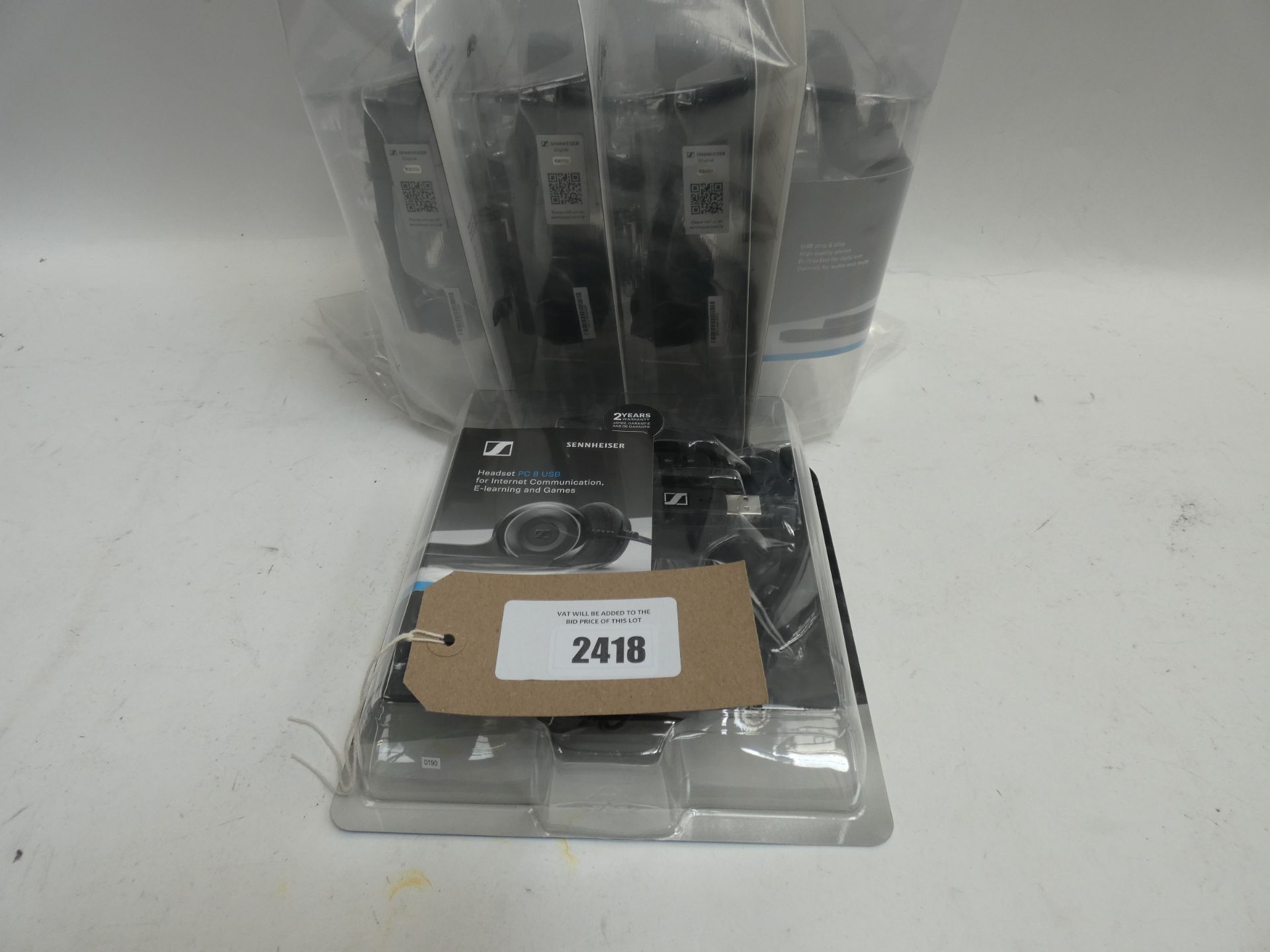 Bag of Five Sennheiser PC 8 usb headsets in blister packs.