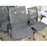 Steel Cases grey upholstered mesh back swivel office armchair