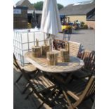 Wooden circular garden table with 5 folding chairs and cream parasol