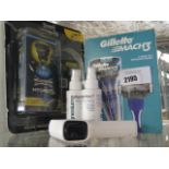 Packs of disposable razors, magnesium oil and contactless thermometer