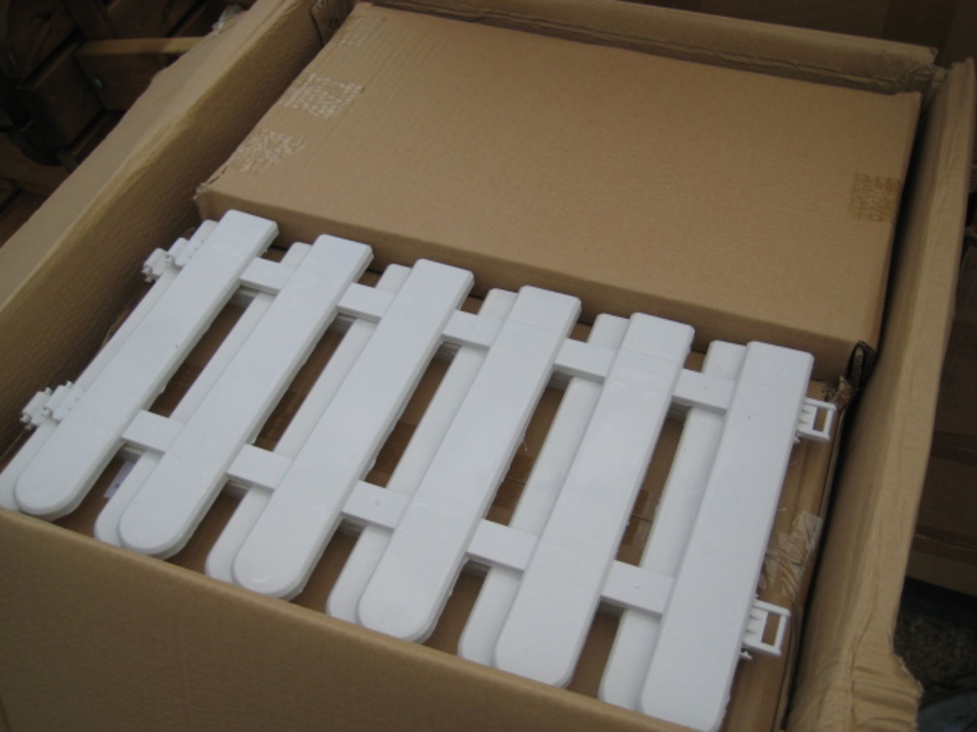 2 boxes containing 40 units in total of white interlocking picket fencing