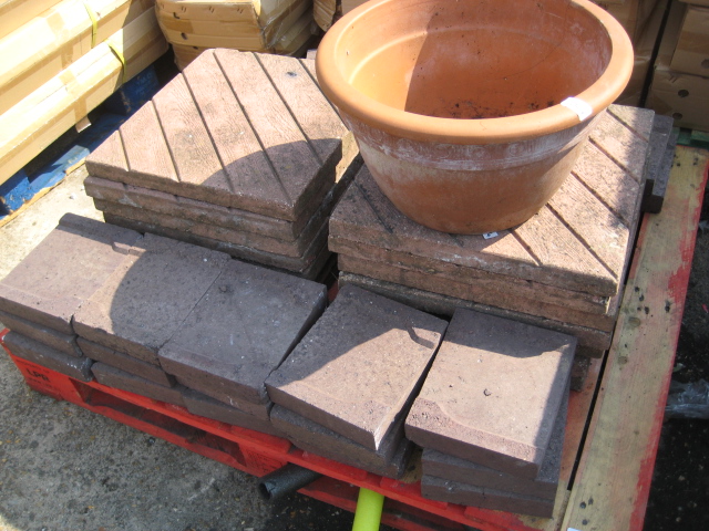 Pallet containing 14 concrete paving slabs with 24 bricks and terracotta plant pot