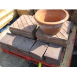 Pallet containing 14 concrete paving slabs with 24 bricks and terracotta plant pot