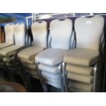 28 stackable cream fleck upholstered metal framed dining chairs by Burgess Furniture