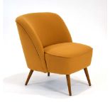 A 1960's German cocktail chair with mustard upholstery and beech tapering legs,