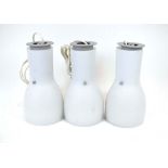 A set of three contemporary frosted glass pendant lights with aluninium innner shades