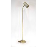 A 1970's single spot standard lamp with a brass coloured shaft CONDITION REPORT: