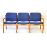 A Danish three-seater sofa, the oak frame with blue fabric upholstery,