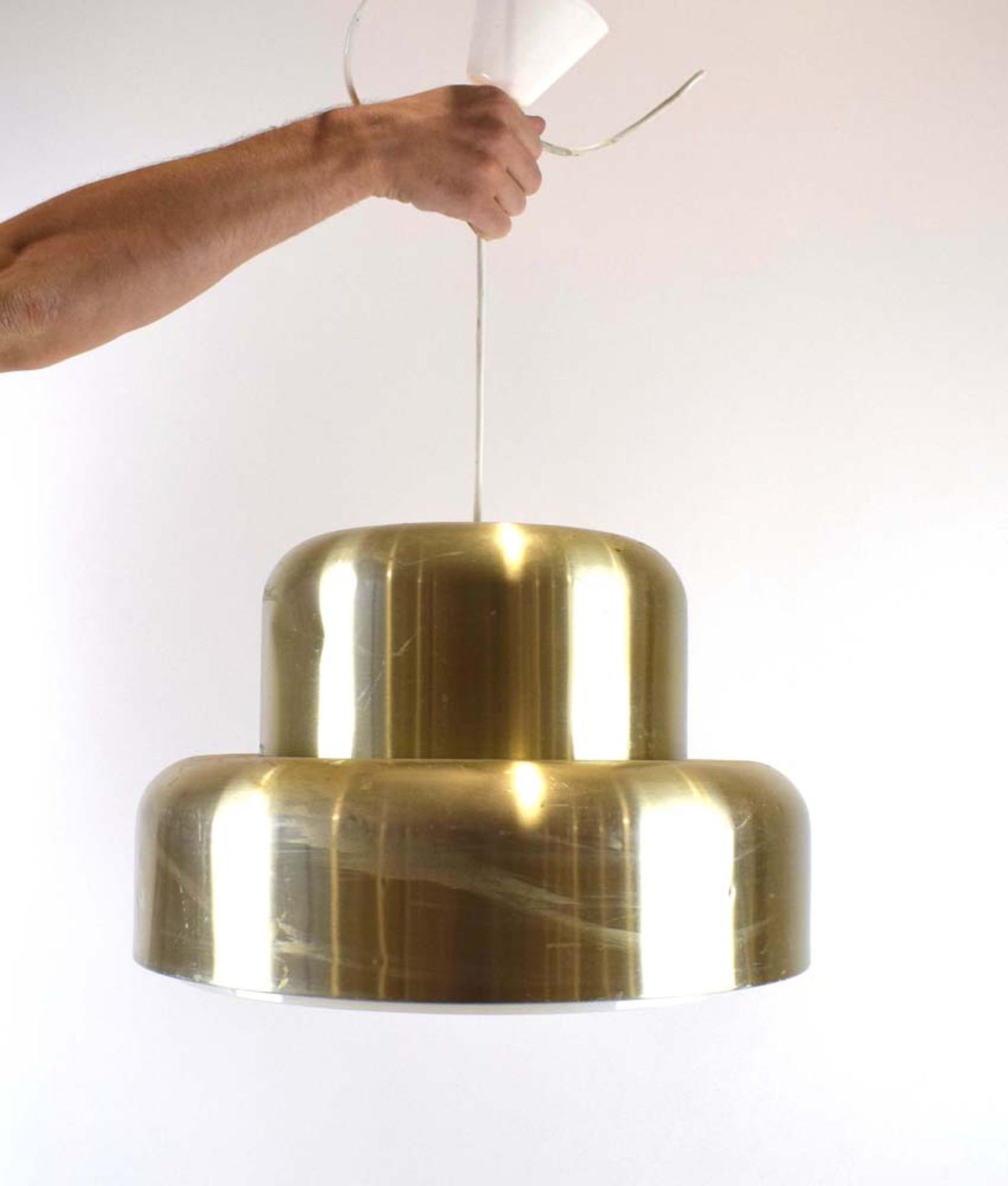 A 1970's brass-coloured ceiling light of wide form with a perspex diffuser CONDITION