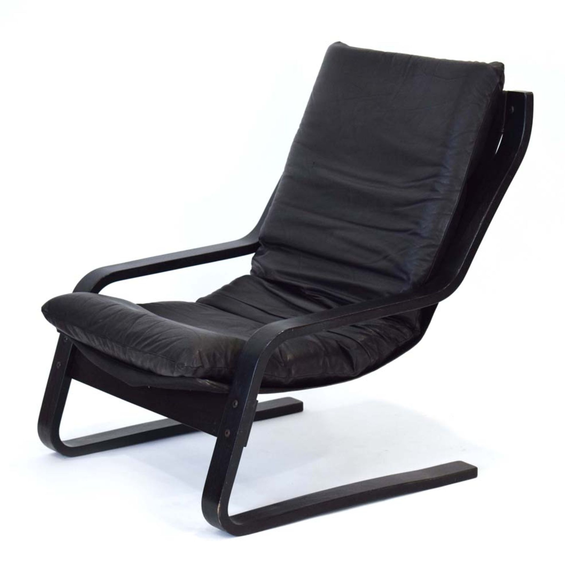 A 1970's armchair, the leather cushion on a black ash bentwood frame, in the manner of Alvar Aalto,