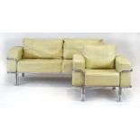 After Le Corbusier, a chrome framed two-seater sofa together with a matching armchair,