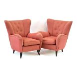 A pair of 1950's Italian wingback and button upholstered armchairs on sweeping feet *Sold Subject