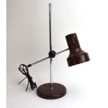 A 1970's brown enamelled desk lamp with an adjustable shade on an aluminium shaft