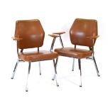 A pair of Swedish armchairs with tan vinyl upholstery, teak angular arms and chromed frames,