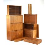 A 1960's Danish teak modular shelving system including two bureaus, three sliding door cabinets,