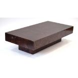 A 1970's Italian simulated burr walnut coffee table of rectangular form on a plinth,