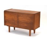 A 1970's teak cabinet, the two doors enclosing a single shelf, w.