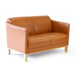 A Danish tan leather two-seater sofa on square oak legs, l.