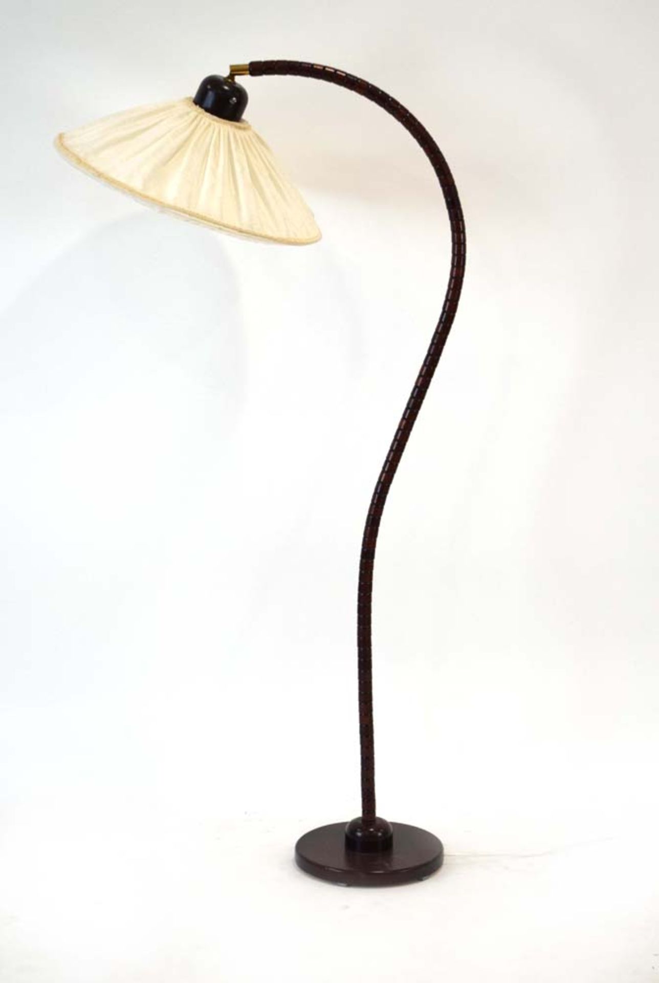 A 1970's stained beech undulating standard lamp with a fabric shade CONDITION REPORT: