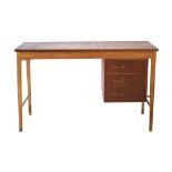 A 1960's teak and oak desk, the surface lifting to reveal a mirrored compartment,