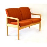 A 1980's two-seater sofa with an oak circular frame and orange fabric upholstery *Sold Subject
