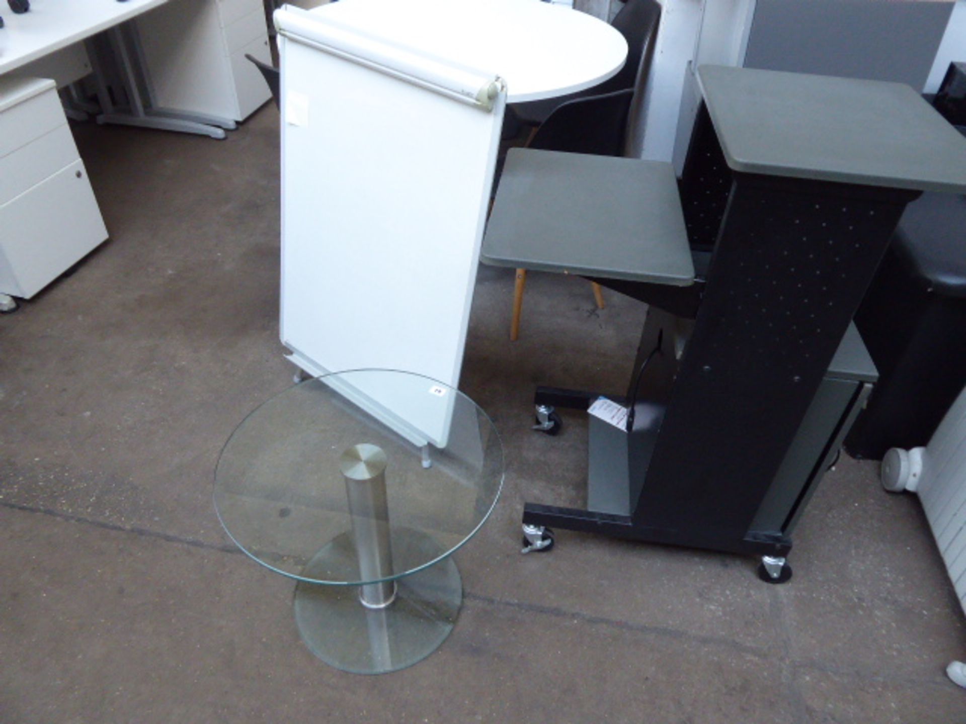 Small glass circular table with a projector mobile mobile console and an A frame white board