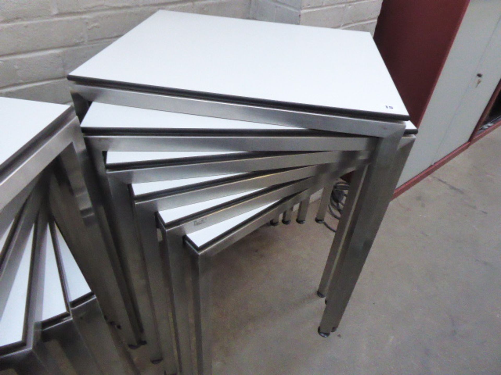 Stack of 6 stainless steel and white top 60cm x 50cm rectangular stackable tables suitable for