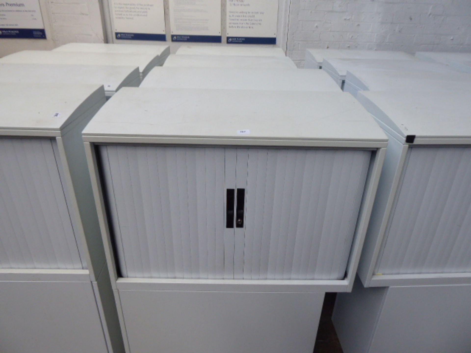 4 grey office storage units and a tambour top single pedestal drawer under