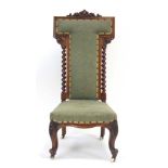 A Victorian mahogany and upholstered prie dieu with barley twist supports,