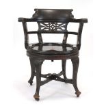 An early 20th century stained oak tub chair,