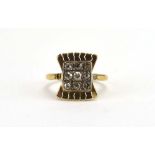 An early 20th century yellow metal ring of bow design set nine old cut diamonds, ring size N, 3.