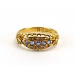 An early 20th century 18ct yellow gold ring of marquise form set pale blue stones and diamonds,