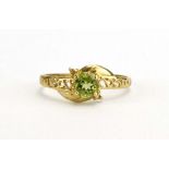 A 9ct yellow gold ring set (?)peridot and two small diamonds in an openwork setting, ring size O,