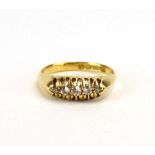 An 18ct yellow gold ring set five graduated diamonds in a raised openwork setting, Birmingham 1918,