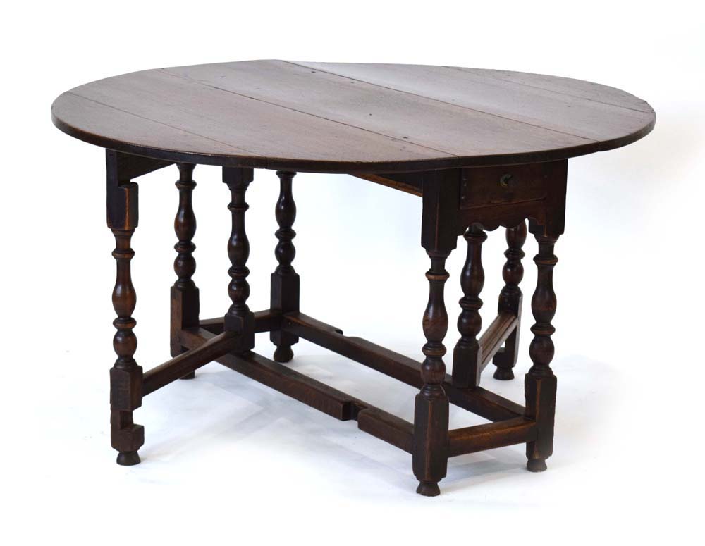 An 18th century oak gateleg table with a single frieze drawer on turned supports joined by - Image 3 of 5