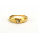 An early 20th century 18ct yellow gold ring set small diamond in a recessed star setting,