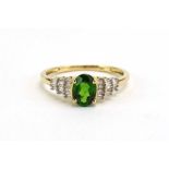 A modern 9ct yellow gold ring set oval chrome diopside in a four claw setting,