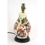 A Moorcroft table lamp base decorated with stylised flowerheads on a cream ground, overall h. 28.